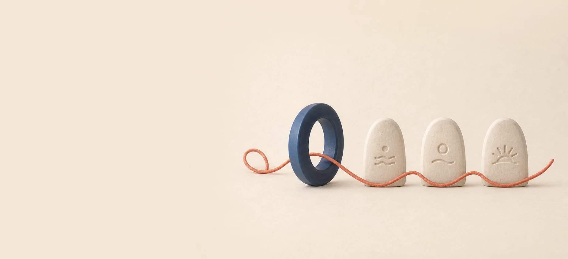 Coral thread flowing through a blue ring and three calm stone markers